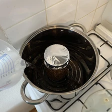 Filling pot with jar inside with water